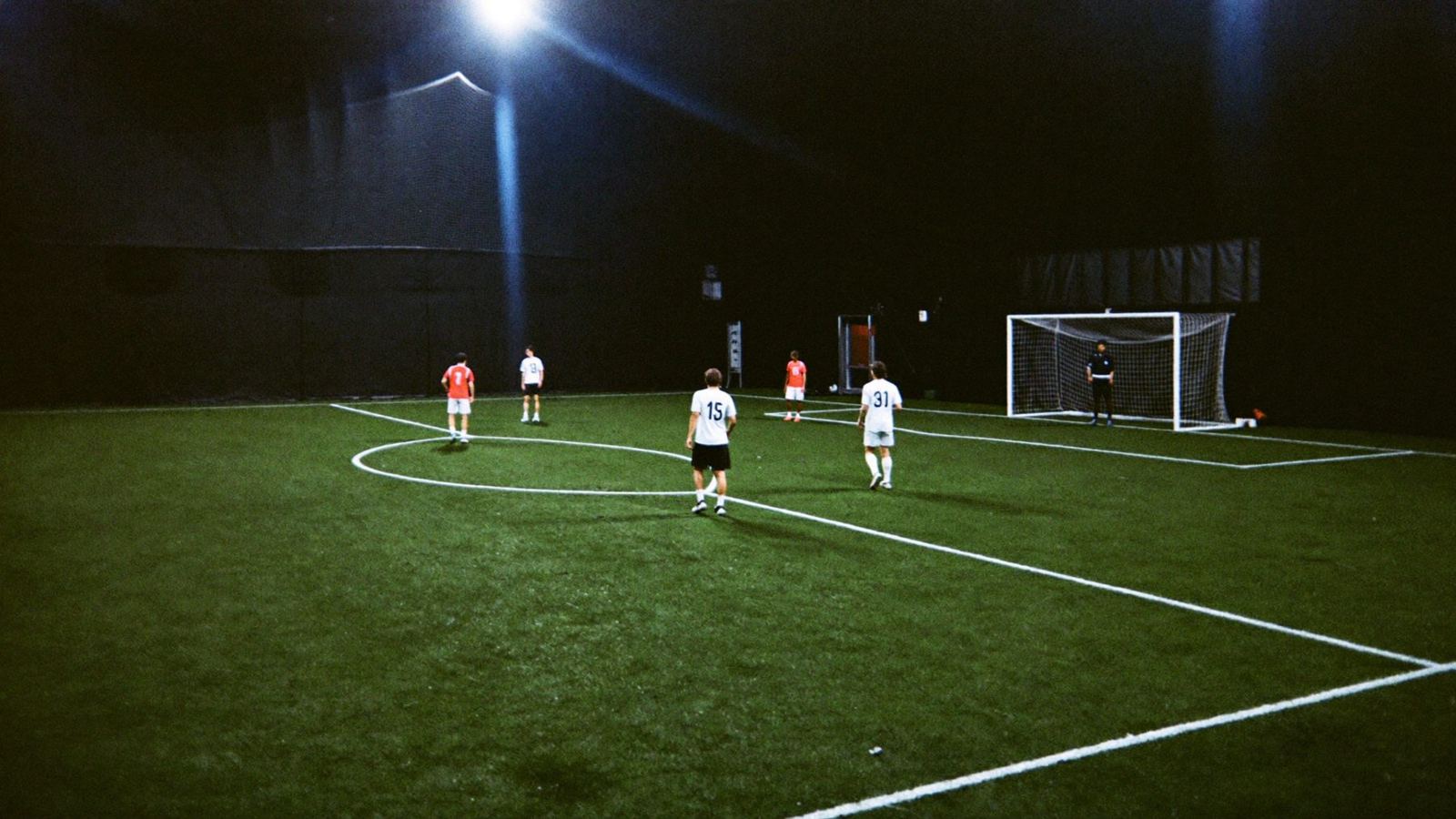 A five-a-side match under the lights on an indoor field